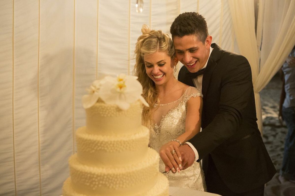 PHOTO: The married couple cut the cake together.