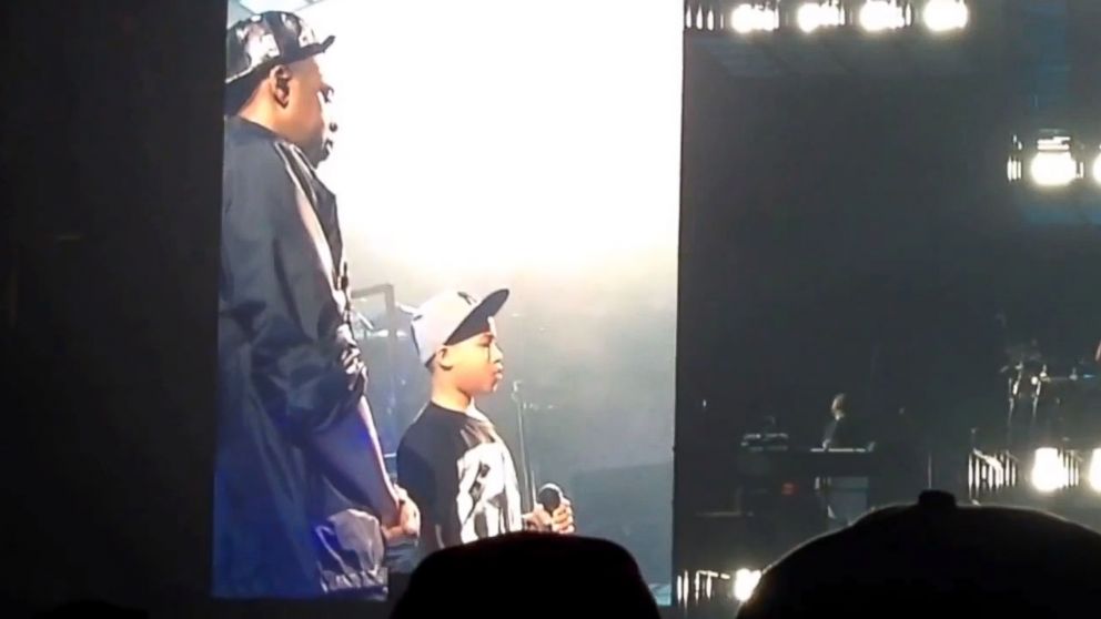 Jay Z hands the microphone to a 12-year-old boy at a concert in Greensboro, N.C., Jan. 5, 2014.