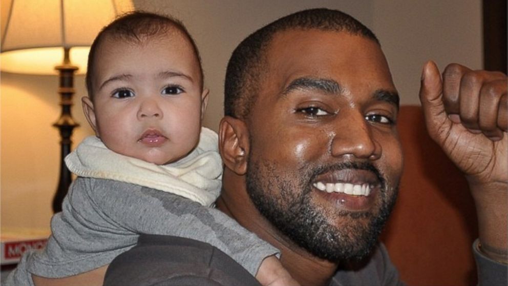 Kanye West smiles with his daughter North West in a photo Kim Kardashian posted to Instagram, Jan. 17, 2014.