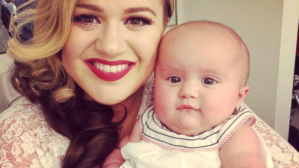 Kelly Clarkson posted this photo with her daughter, River, to Instagram, Oct. 6, 2014, with the caption, "River is visiting me on the set of my new music video shoot for Wrapped In Red! #babysfirstvideo."