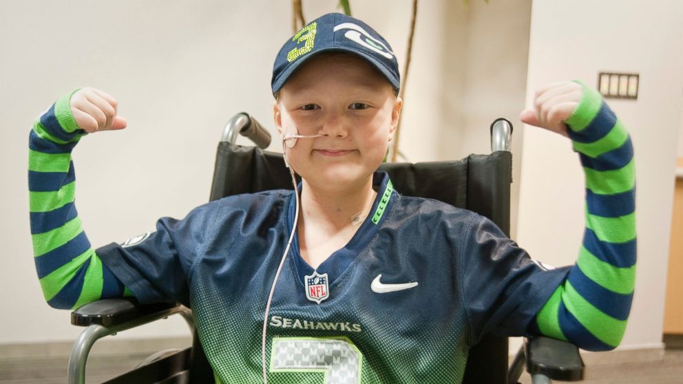 PHOTO: Seattle Children's Hospital patient, Kennedy O'Day flexes for Strong Against Cancer in her FiveLo arm socks, Jan. 27, 2015.