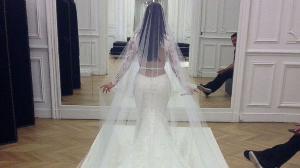 PHOTO: Kim Kardashian had one last fitting of her Givenchy Haute Couture lace gown at the Givenchy atelier in Paris before the wedding ceremony. <a href="http://www.eonline.com/news/545405/kim-kardashian-and-kanye-west-s-first-photos-as-a-married-couple-s