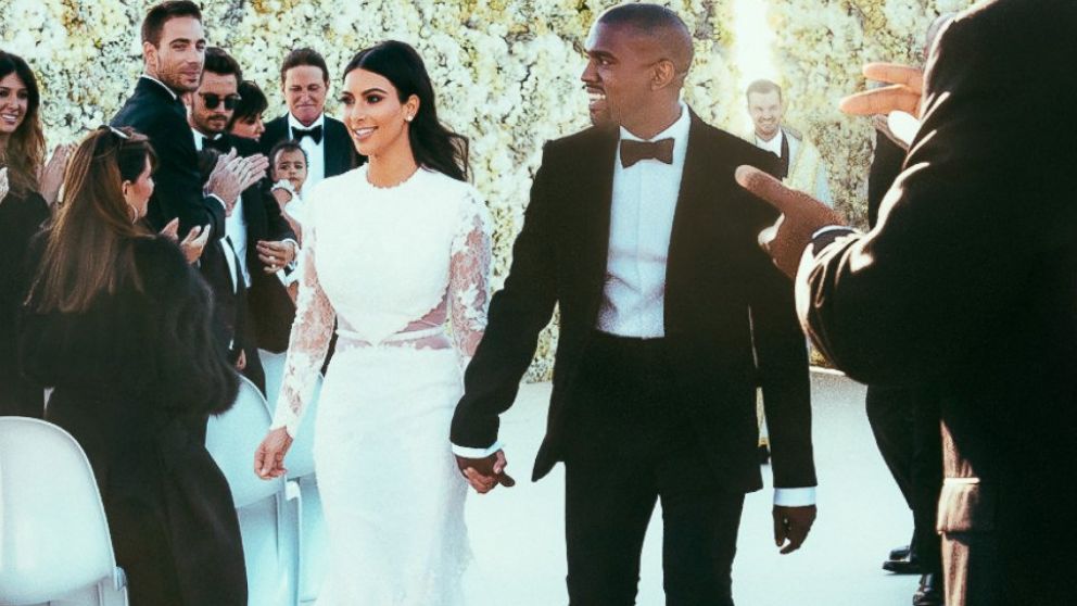 Newlyweds Kanye West and Kim Kardashian walk down the aisle as friends and family look on at the Forte di Belvedere in Florence, Italy, May 24, 2014.  E! News published  the first photos of the happy couple.