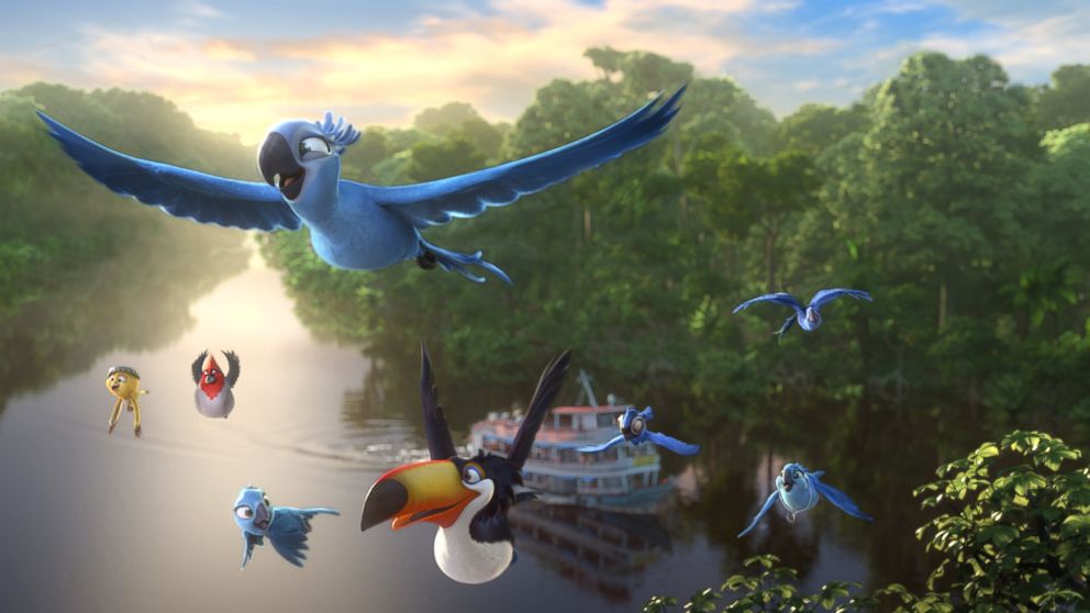 Blu, Jewel and their family fly above the Amazon River in a scene from Rio 2.
