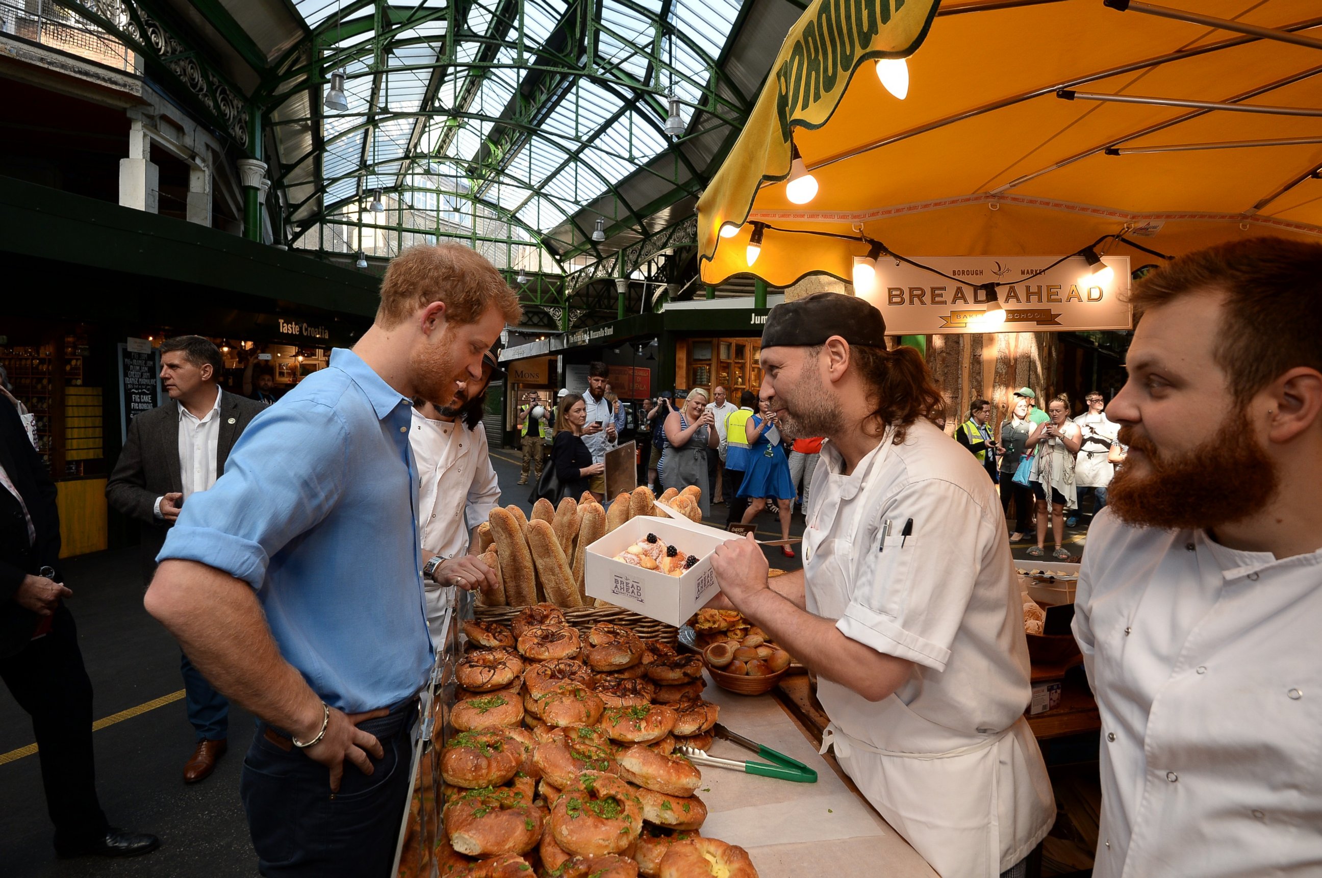 PHOTO: Prince Harry buys doughnuts from "Bread Ahead" stall during a visit to Borough Market in London, which has opened yesterday for the first time since the London Bridge terrorist attack, June 15, 2017. 