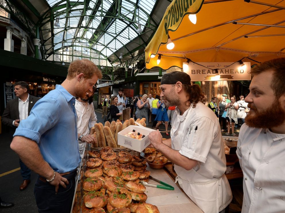 PHOTO: Prince Harry buys doughnuts from Bread Ahead stall during a visit to Borough Market in London, which has opened yesterday for the first time since the London Bridge terrorist attack, June 15, 2017.