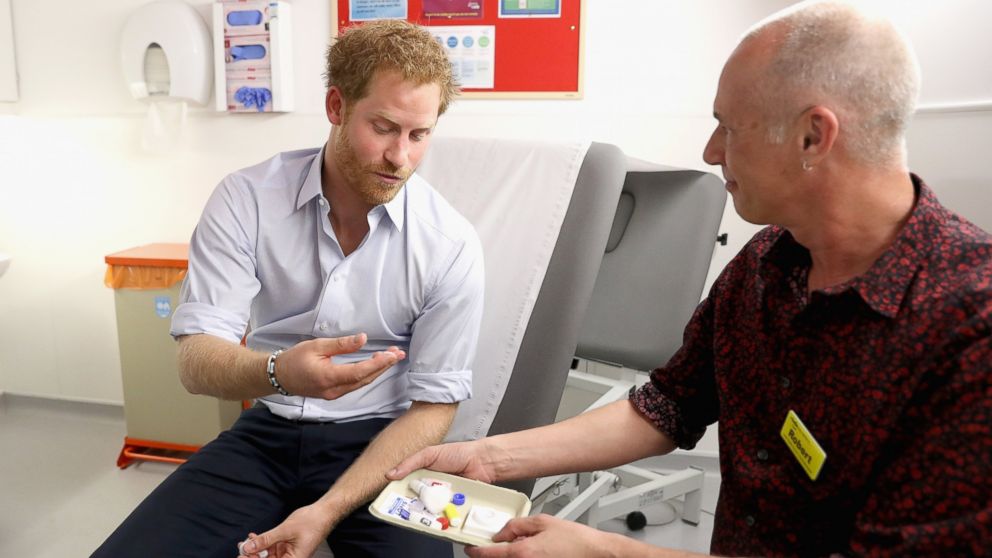 Prince Harry is shown the negative result of his HIV test taken by Specialist Psychotherapist Robert Palmer during a visit to Burrell Street Sexual Health Clinic on July 14, 2016 in London, England. 