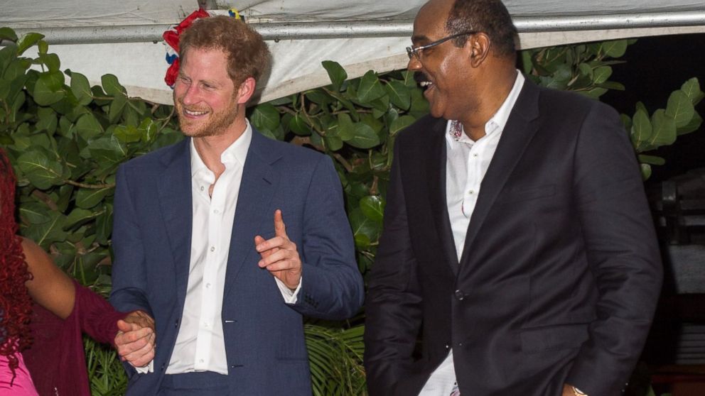 Prince Harry attends a reception hosted by the Prime Minister Gaston Browne, right, at Barnacle Point, Antigua, Nov. 21, 2016. 


