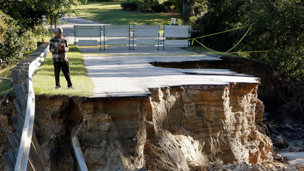 PHOTO: A resident surveys the scene of a washed out road after Hurricane Matthew struck the state, in Fayetteville, North Carolina, Oct. 10, 2016.   