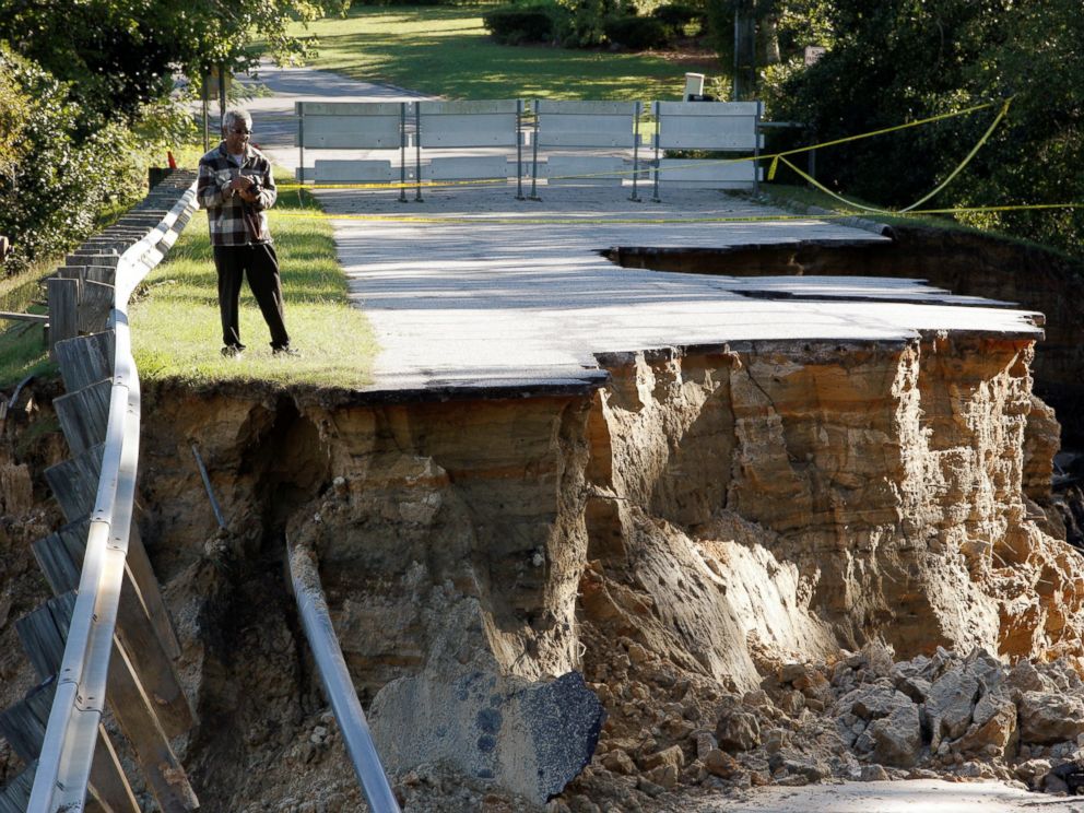 PHOTO: A resident surveys the scene of a washed out road after Hurricane Matthew struck the state, in Fayetteville, North Carolina, Oct. 10, 2016.