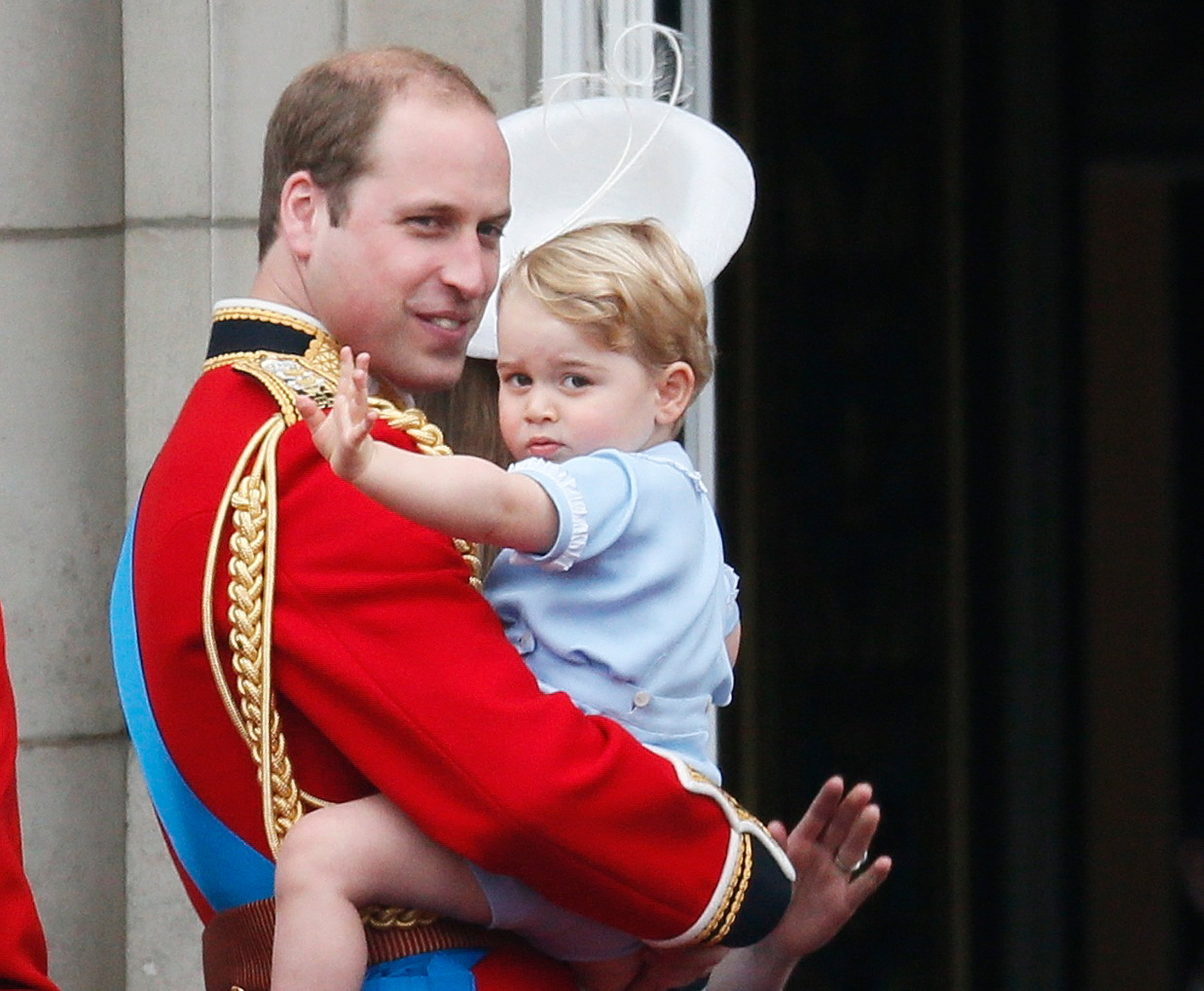 PHOTO: Britain's Prince William holds Prince George as he waves from the balcony at Buckingham Palace after the Trooping The Color ceremony in central London, June 13, 2015. 