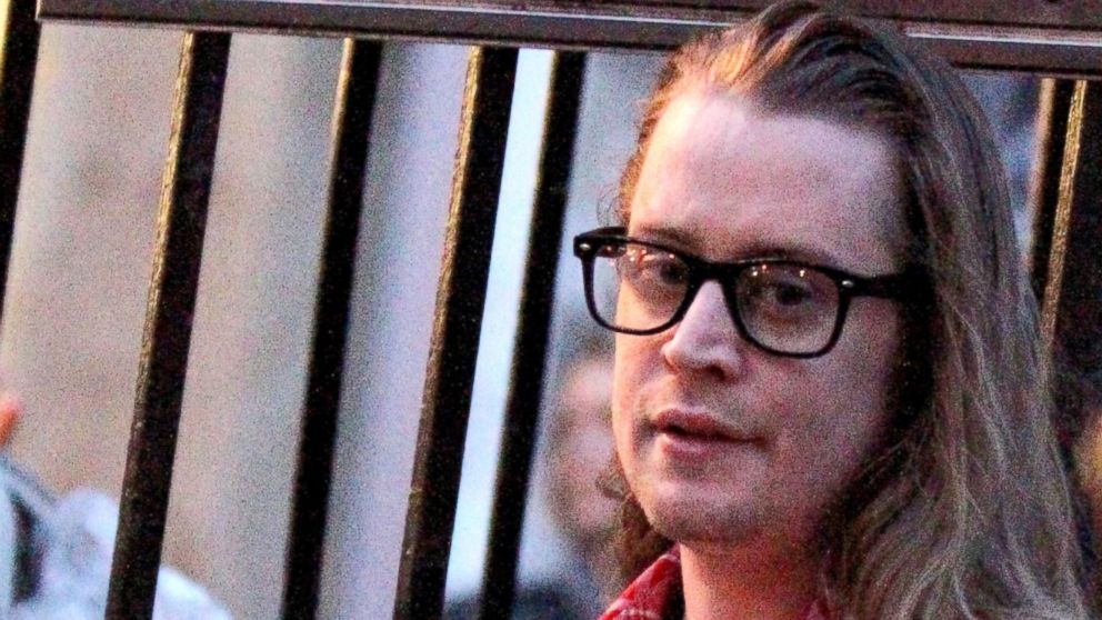 PHOTO: Macaulay Culkin pictured standing outside on the fire escape stairs as he films scenes for "The Jim Gaffigan Show" in New York, March 13, 2016.
