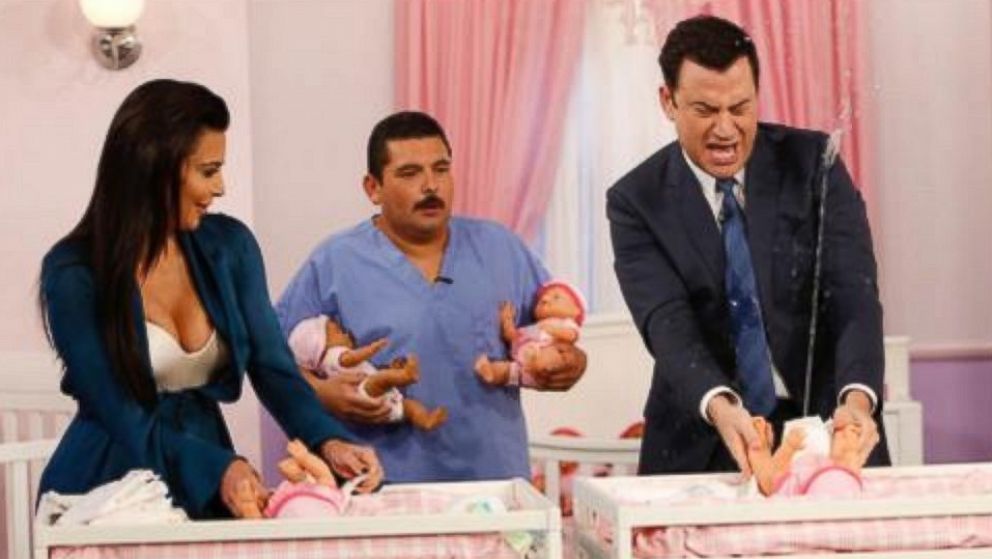 Kim Kardashian and Jimmy Kimmel change diapers in a contest on "Jimmy Kimmel Live," Aug. 4, 2014.