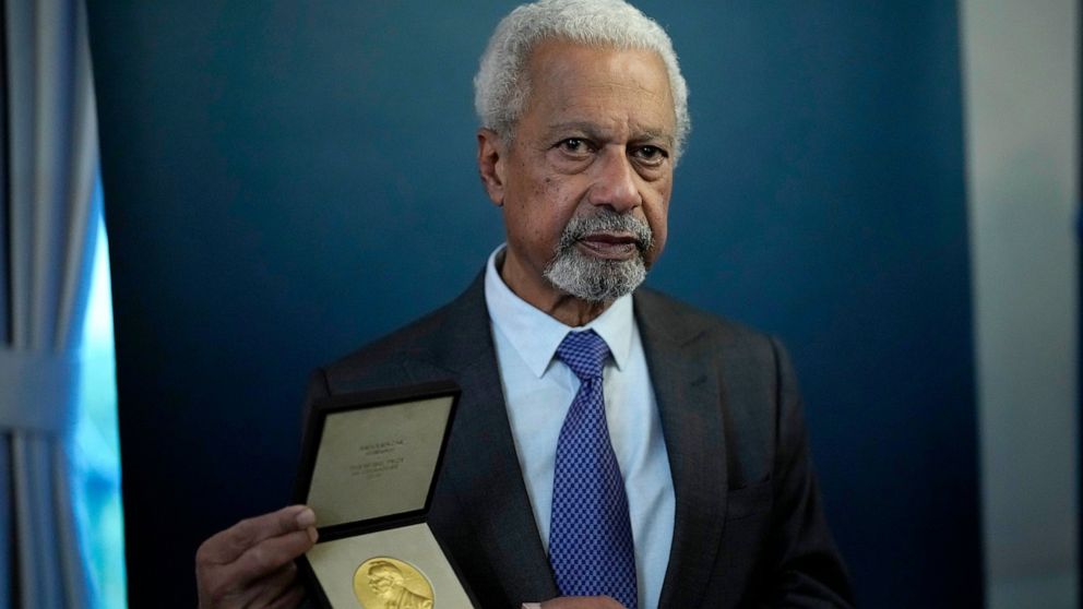Abdulrazak Gurnah, a Tanzanian-born novelist and emeritus professor who lives in the UK, poses for photographs with his 2021 Nobel Prize for Literature medal after being presented it by the Ambassador of Sweden Mikaela Kumlin Granit in a ceremony at 