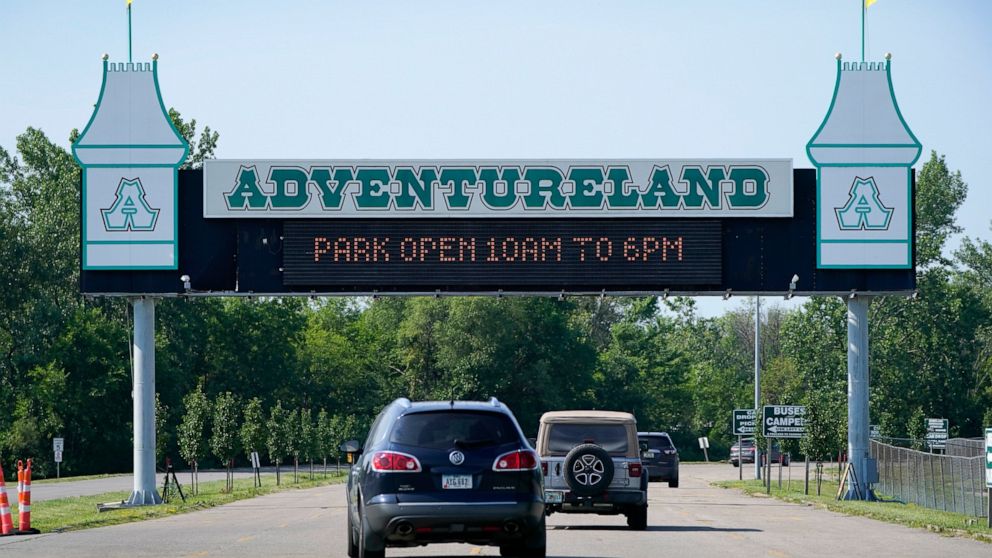 Visitors arrive at the Adventureland Park amusement park, Tuesday, July 6, 2021, in Altoona, Iowa. The father of an 11-year-old boy who died following an accident on the popular boat ride at the park said that his son and other family members were tr