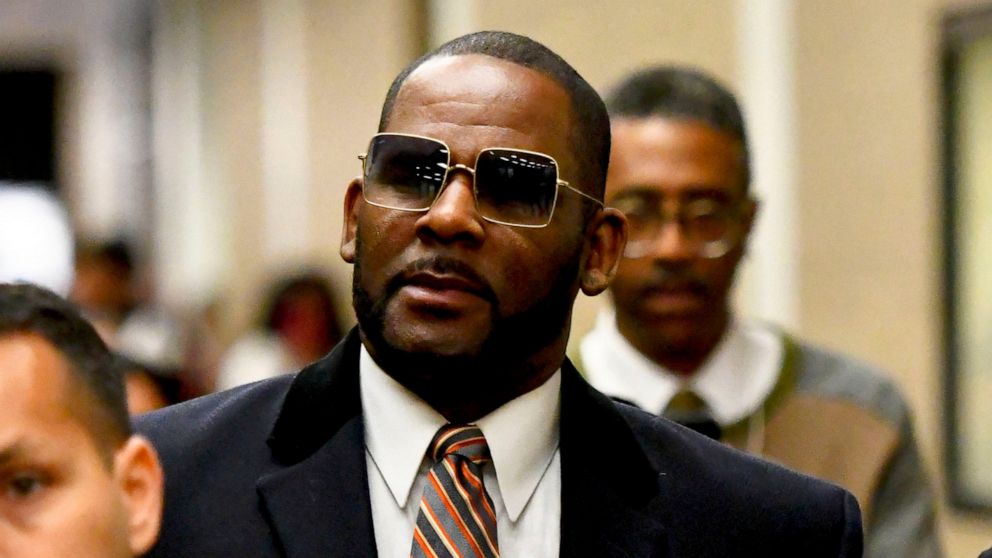 FILE - Musician R. Kelly, center, leaves the Daley Center after a hearing in his child support case on May 8, 2019, in Chicago. Closing arguments are scheduled Monday, Sept. 12, 2022 for R. Kelly and two co-defendants in the R&B singer’s trial on fed