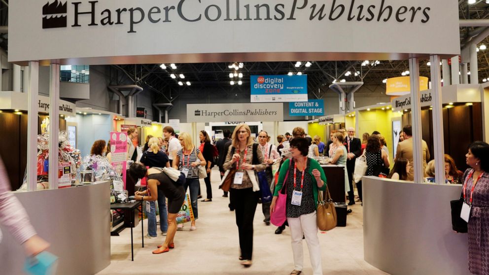 FILE - Attendees at BookExpo America visit the HarperCollins Publishers booth in New York on May 28, 2015. Some 250 copy editors, marketing assistants and other employees at HarperCollins Publishers went on strike Thursday, with the two sides differi