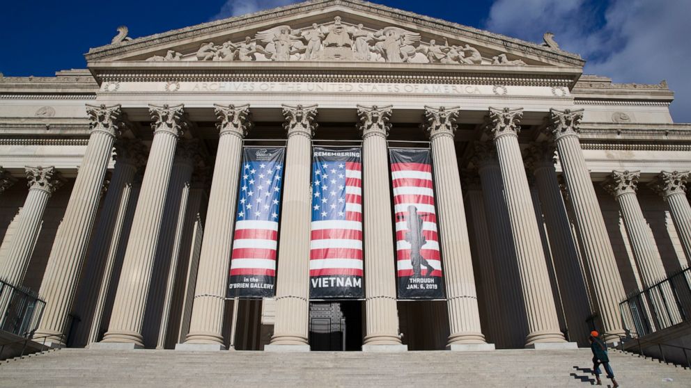 FILE - People walk up the steps even though the National Archives is closed with the partial government shutdown, Dec. 22, 2018 in Washington. While the Archives safeguards precious national documents such as the Declaration of Independence, the Cons