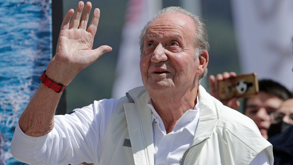 FILE - Spain's former King Juan Carlos waves before a reception at a nautical club prior to a yachting event in Sanxenxo, northwestern Spain, on, May 20, 2022. Spain’s former king has decided to postpone a second visit home since he established resid