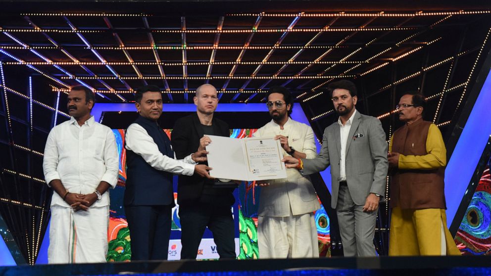 This photograph released by Indian government's Press Information Bureau shows Israel filmmaker and jury chairperson Nadav Lapid, third left, being honored by Indian ministers at the closing ceremony of the International Film Festival of India in Goa