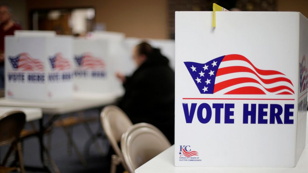 FILE - A woman votes in the presidential primary election at the the Summit View Church of the Nazarene in Kansas City, Mo., on March 10, 2020. Newspaper endorsements for candidates are fading away, a victim of both the news industry's troubles and t