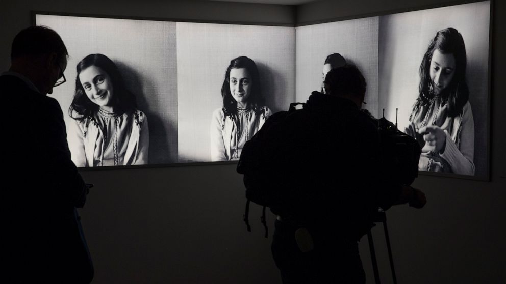 FILE - Journalists take images of the renovated Anne Frank House Museum in Amsterdam, Netherlands, Wednesday, Nov. 21, 2018. The Anne Frank House museum is releasing on Thursday, Aug. 4, 2022, an English-language version of a series of three videos i