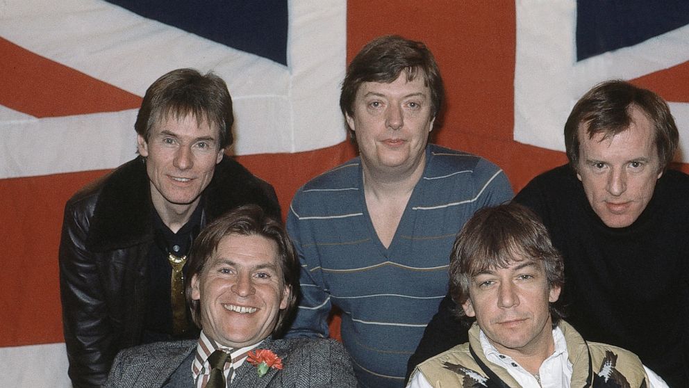 FILE - In this April 7, 1983 file photo, British pop group The Animals, from left, Hilton Valentine, Chas Chandler, John Steel, front row, Alan Price, and Eric Burdon, pose for photographers after announcing plans for a world tour, in London, England