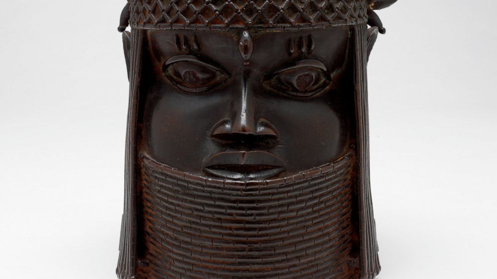 A bronze sculpture called the "Head of a King" or "Oba," probably from the 1700s, rests in front of a white background, Dec. 13, 2004, in Providence, R.I. The bronze sculpture, one the Benin Bronzes, of a West African king, had been in the collection