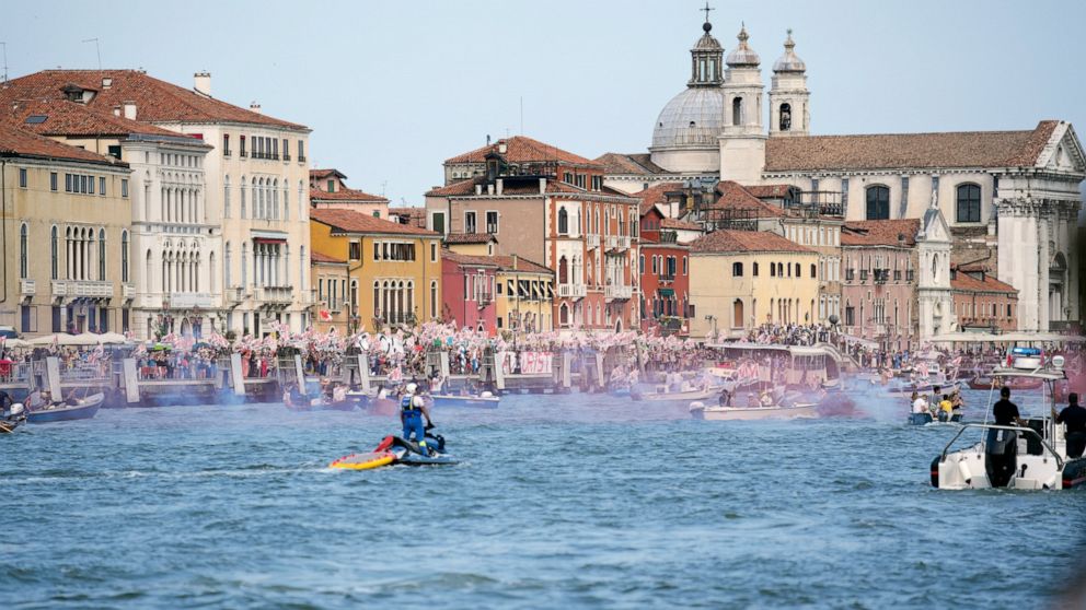 FILE - In this June 5, 2021 file photo, "No Big Ships" activists stage a protest as the MSC Orchestra cruise ship leaves Venice, Italy. UNESCO’s World Heritage Committee is debating Thursday, July 22, 2021, whether Venice and its lagoon environment w