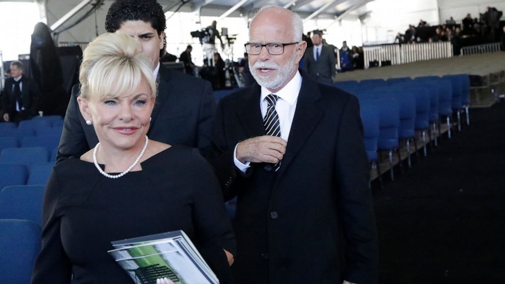 FILE - In this March 2, 2018 file photo, Televangelist Jim Bakker, right, walks with his wife Lori Beth Graham after a funeral service at the Billy Graham Library for the Rev. Billy Graham, in Charlotte, N.C. Jim Bakker and his southwestern Missouri 