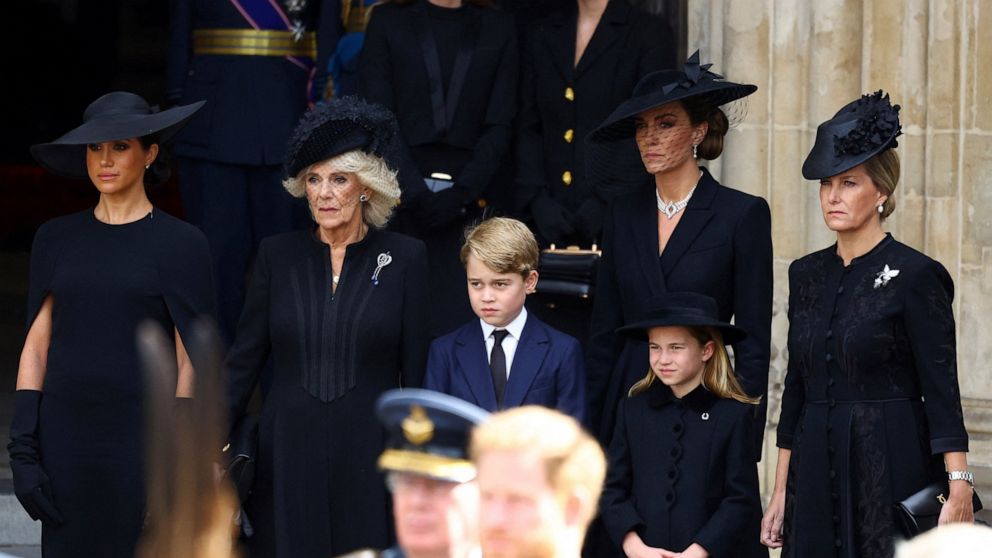 Camilla, the Queen Consort, Prince George, Princess Charlotte, Kate, Princess of Wales, Meghan, Duchess of Sussex and Sophie, Countess of Wessex stand after a service at Westminster Abbey on the day of the state funeral and burial of Britain's Queen 
