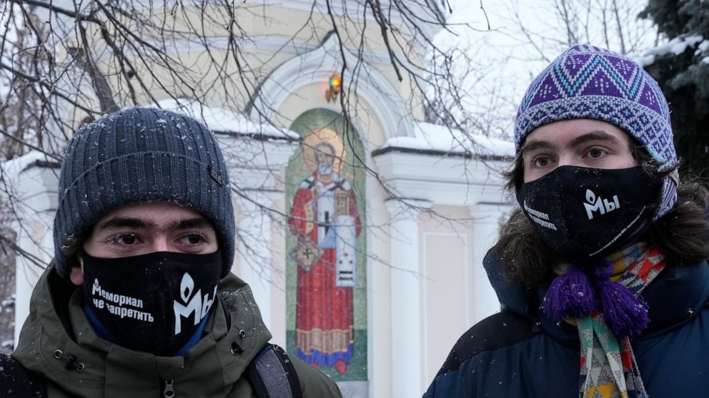 FILE - Supporters of the Memorial human rights group wearing face masks with the words "The Memorial cannot be banned!" gather in front of the Moscow Court in Moscow, Russia, Wednesday, Dec. 29, 2021. On Friday, Oct. 7, 2022 the Nobel Peace Prize was