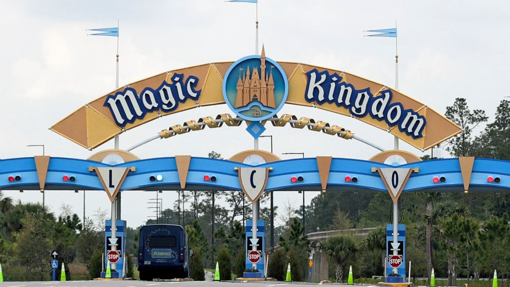 FILE - In this March 16, 2020, file photo, the entrance to the parking lot at the Magic Kingdom at Walt Disney World is closed in Lake Buena Vista, Fla. The House of Mouse is struggling. Its second quarter profit dropped as the company took a $1.4 bi