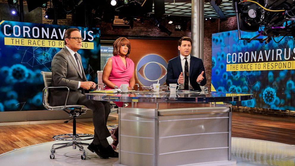 This March 6, 2020 photo released by CBS shows co-hosts, from left, Anthony Mason, Gayle King and Tony Dokoupil reporting on the coronavirus on "CBS This Morning" in New York. CBS News shut down its New York City headquarters for cleaning and disinfe