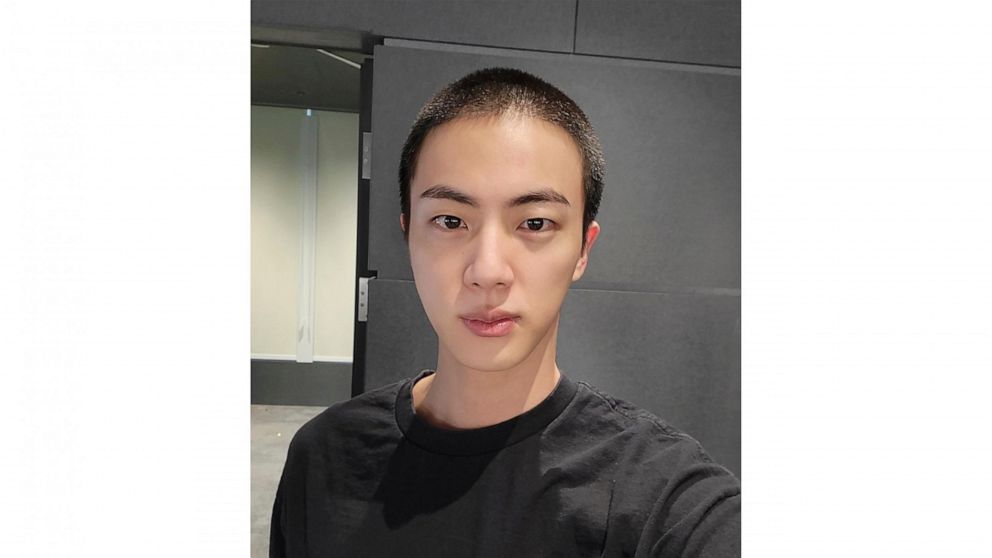 In this photo provided by Weverse, Jin of K-pop band BTS shows off freshly shaved hair on the K-pop social media platform Weverse, which was uploaded Sunday, Dec. 11, 2022, ahead of his upcoming military conscription. Jin, the oldest member of K-pop 