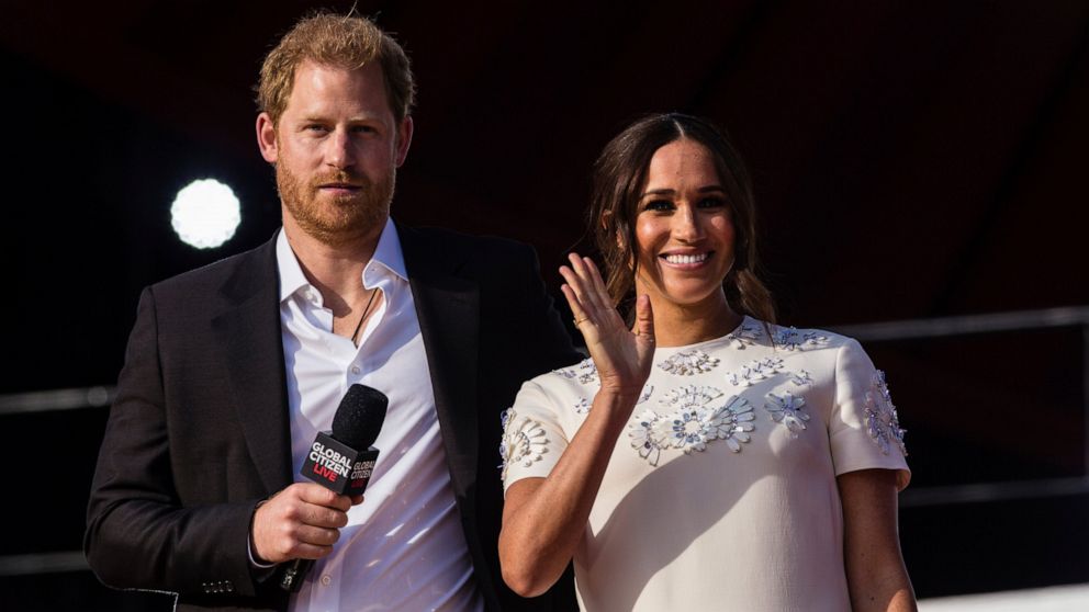 FILE - Prince Harry and his wife Meghan speak during the Global Citizen festival, on Sept. 25, 2021 in New York. Prince Harry and his wife Meghan have visited Queen Elizabeth II at Windsor Castle on their first joint visit to the U.K. since they gave