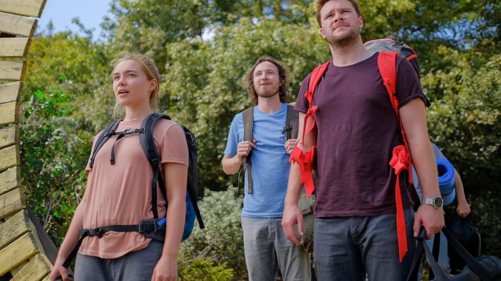 This image released by A24 shows Jack Reynor, right, and Florence Pugh in a scene from the horror film "Midsommar." (Gabor Kotschy/A24 via AP)