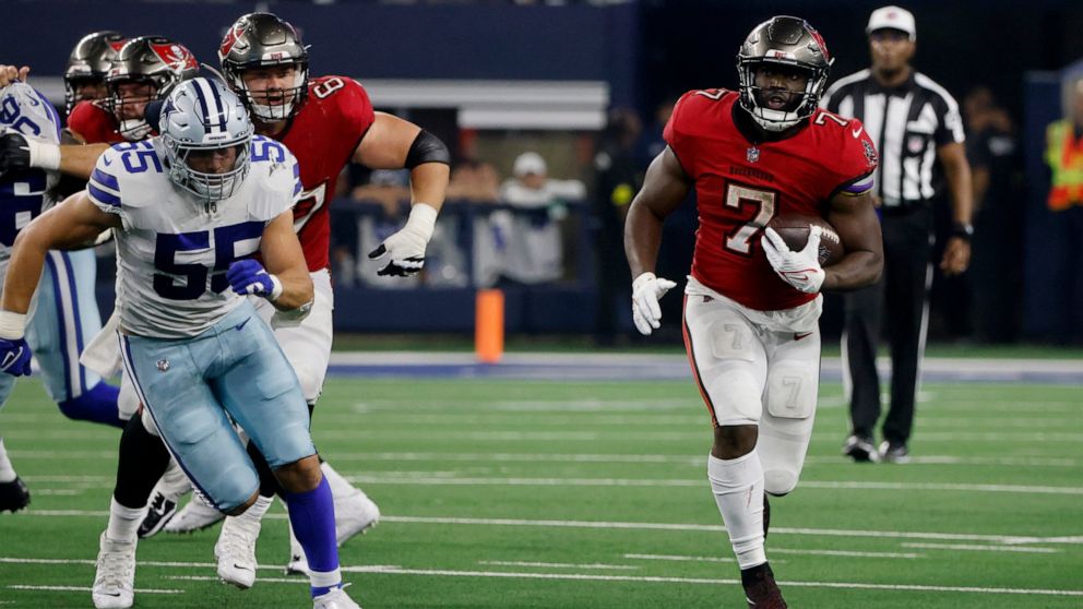 Dallas Cowboys linebacker Leighton Vander Esch (55) gives chase as Tampa Bay Buccaneers running back Leonard Fournette (7) runs the ball for a long gain in the second half of a NFL football game in Arlington, Texas, Sunday, Sept. 11, 2022. (AP Photo/