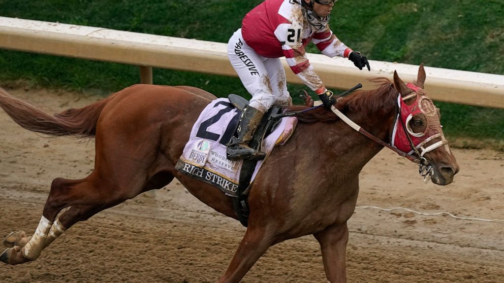 Sonny Leon celebrates after riding Rich Strike to victory in the 148th running of the Kentucky Derby horse race at Churchill Downs Saturday, May 7, 2022, in Louisville, Ky. (AP Photo/Charlie Riedel)