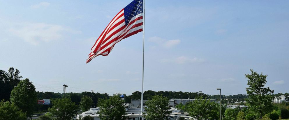 FILE - In this undated handout photo provided by Camping World, an American flag blows in the wind at Gander RV, in Statesville, N.C. The North Carolina city has voted against the flying of really big flags, holding its ground against reality TV star
