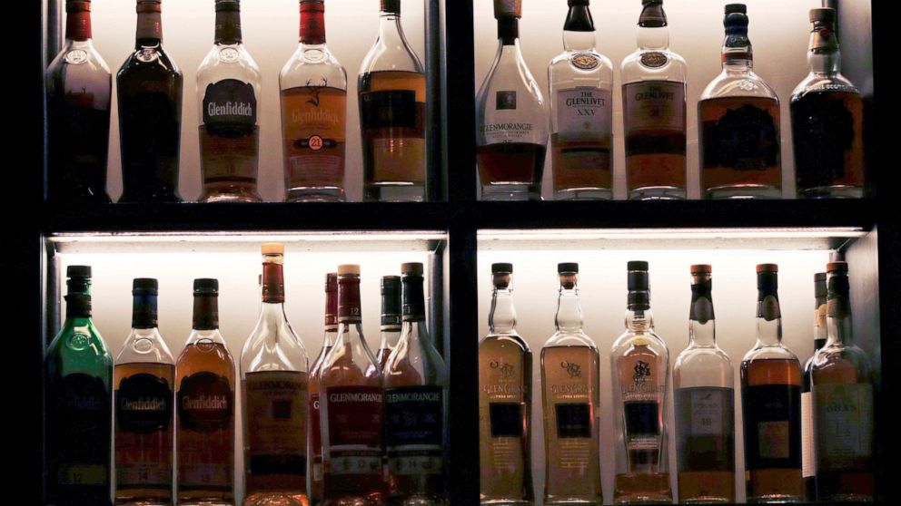 FILE - A vast array of single malt scotch bottles are displayed at Wink & Nod, basement-dwelling, speakeasy-like bar, in Boston, on Dec. 10, 2019. In Massachusetts, Democrats and Republicans could find an issue to agree on: letting bars have happy ho