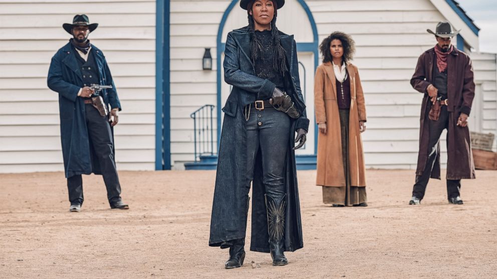This image released by Netflix shows Regina King, center, from the film "The Harder They Fall." (David Lee/Netflix via AP)