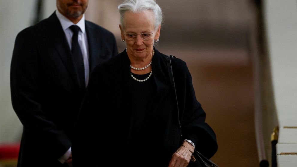 Denmark's Queen Margrethe pays her respect to the coffin of Britain's Queen Elizabeth, following her death, during her lying-in-state at Westminster Hall, in London, Sunday Sept. 18, 2022. (John Sibley/Pool via AP)