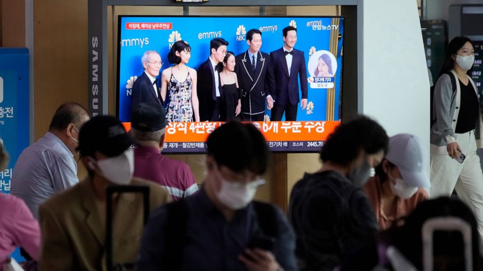 A TV screen show the casting members of Squid Game during a news program at the Seoul Railway Station in Seoul, South Korea, Tuesday, Sept. 13, 2022. (AP Photo/Ahn Young-joon)