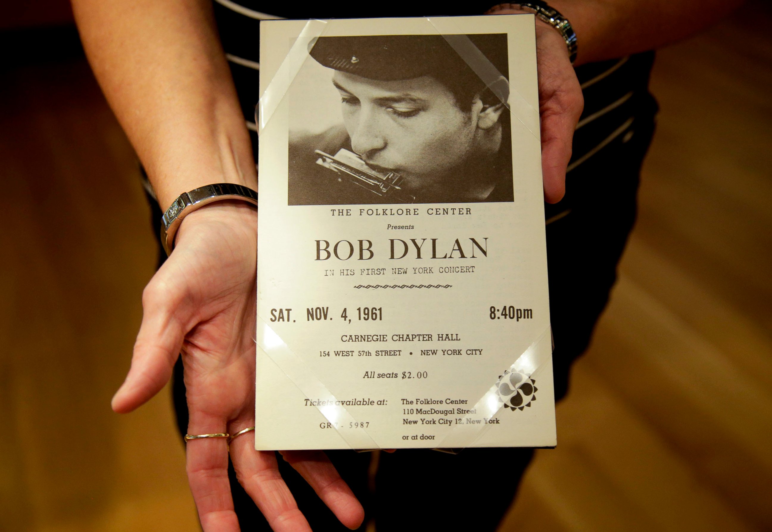 In this Thursday, Oct. 13, 2016 photo, a piece from Bob Dylan's first concert in New York is shown in Tulsa, Okla. A new exhibit on the life and work of Bob Dylan, centered on 12 pastel portraits that make up his “Face Value” series, will go on displ
