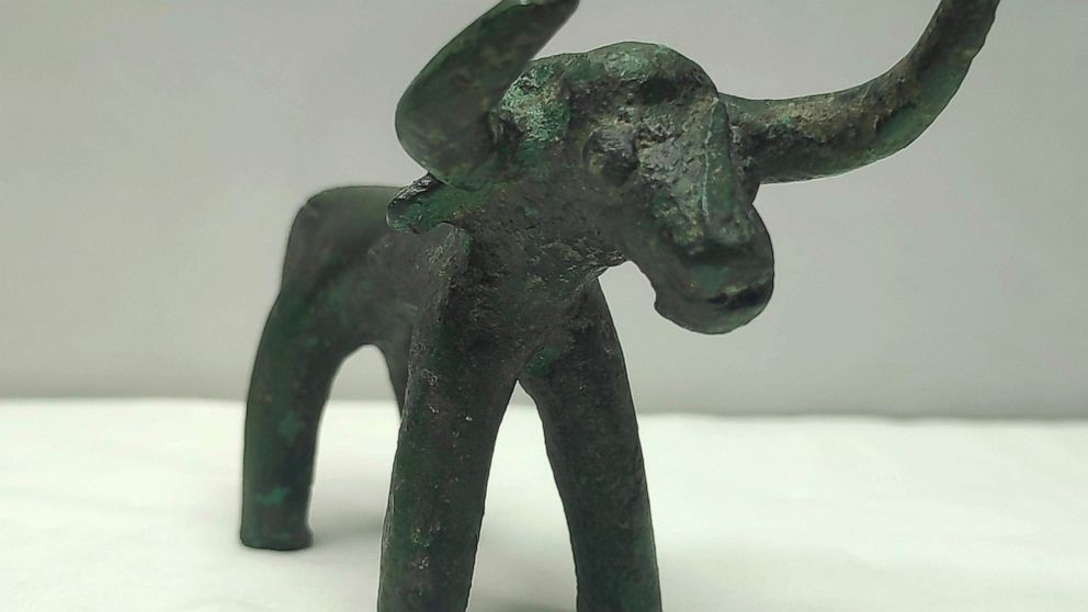 This undated photo provided by the Greek Culture Ministry on Friday, March 19, 2021 shows an ancient bronze bull figurine that was found in ancient Olympia . Heavy recent rainfall in southern Greece has led to the discovery of a bronze bull figurine 