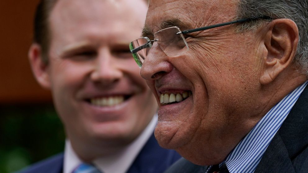 Andrew Giuliani, a Republican candidate for Governor of New York, left, is joined by his father former New York City mayor Rudy Giuliani during a news conference, Tuesday, June 7, 2022, in New York. (AP Photo/Mary Altaffer)