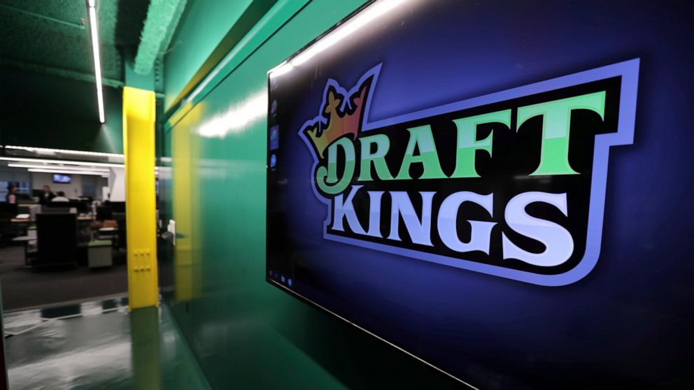 FILE - In this May 2, 2019, file photo, the DraftKings logo is displayed at the sports betting company headquarters in Boston. Sports gambling giant DraftKings won't give a former "Bachelor" contestant the $1 million prize for winning an online fanta