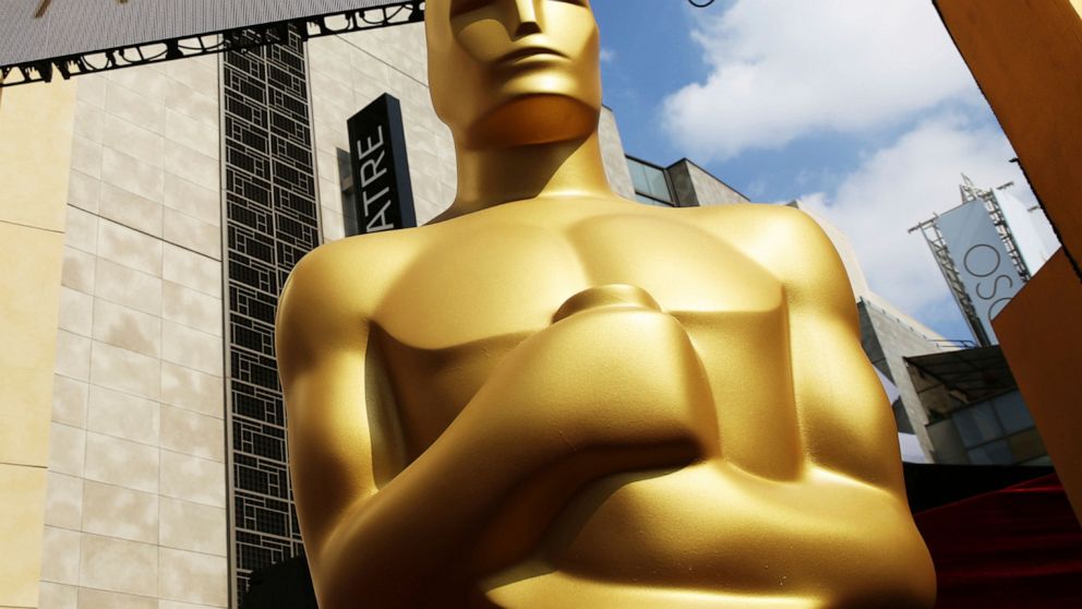 FILE - In this Feb. 21, 2015 file photo, an Oscar statue appears outside the Dolby Theatre for the 87th Academy Awards in Los Angeles. The theater has been the home of the Oscars since 2001 and the organizers say the upcoming show will keep that trad