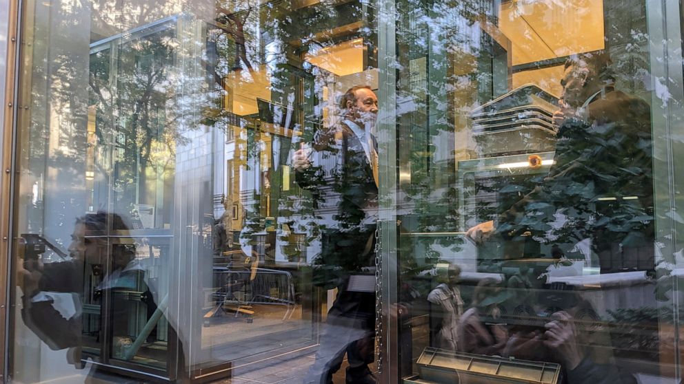 Video journalists and photographers are reflected in the glass as they cover the arrival of actor Kevin Spacey for a civil case at a federal courthouse in lower Manhattan in New York on Thursday, Oct. 20, 2022. (AP Photo/Ted Shaffrey)